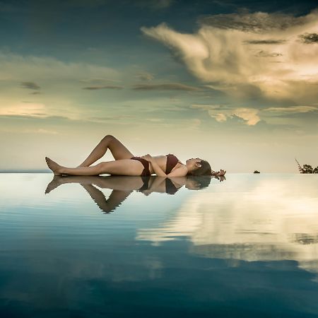 Munduk Moding Plantation Nature Resort Exterior photo A photomontage of a woman lying on a lake